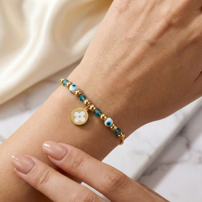 A gold bracelet made of rust-resistant stainless steel, with a thin design adorned with gold and turquoise beads and an elegant eye shape with a white rose pendant, with an adjustable clasp to fit you. - Image 2